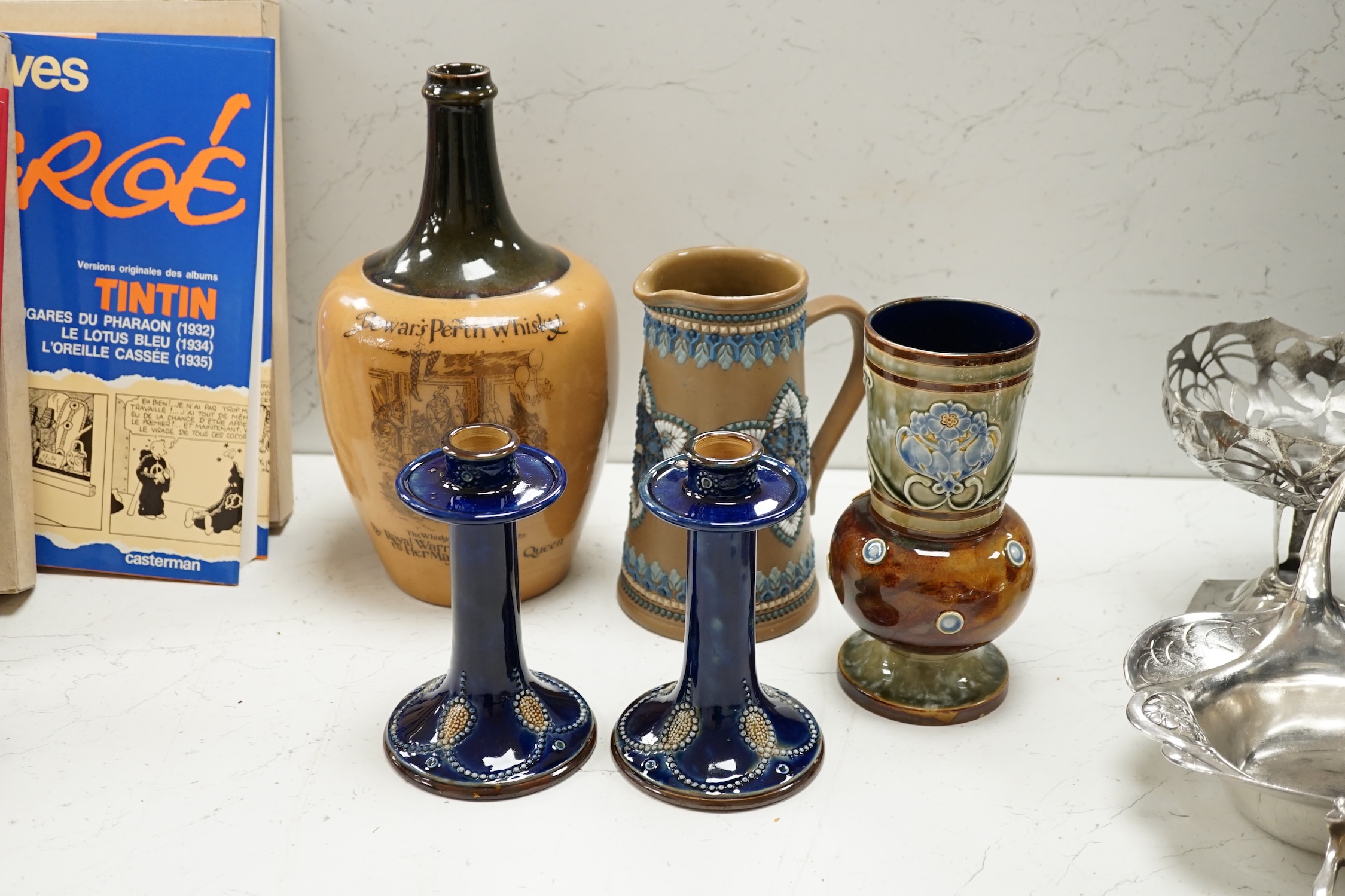 A Doulton Lambeth Dewars Perth whisky flagon, a pair of candlesticks and two other pieces, tallest 29cm. Condition - mostly good, one or two small chips